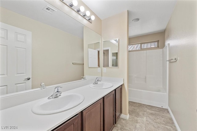 bathroom with tile patterned flooring, vanity, and shower / bathing tub combination