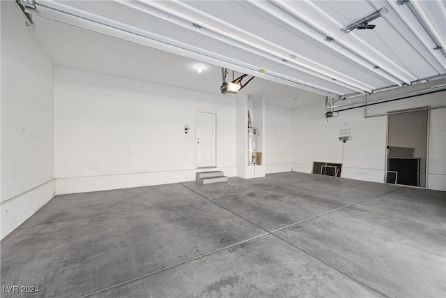 garage featuring secured water heater and a garage door opener