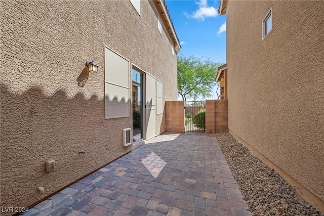 view of property exterior with a patio area