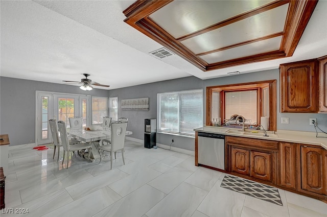 kitchen featuring dishwasher, a wealth of natural light, a tray ceiling, and ceiling fan