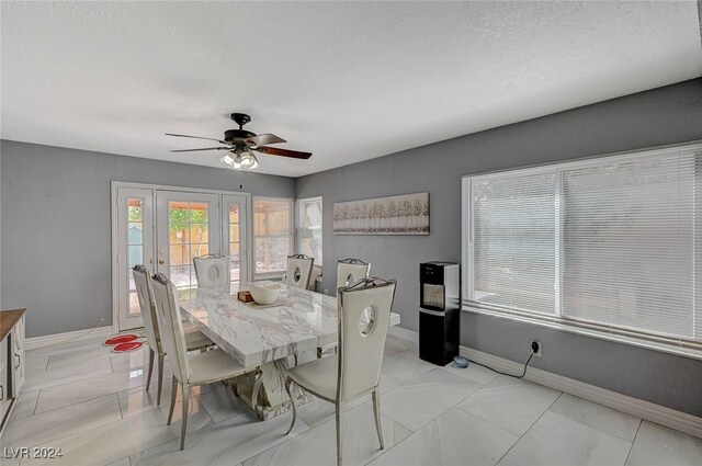 dining room with french doors, a textured ceiling, and ceiling fan