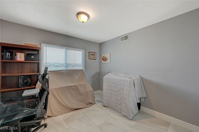 bedroom featuring a textured ceiling