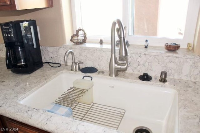 details featuring light stone counters and sink