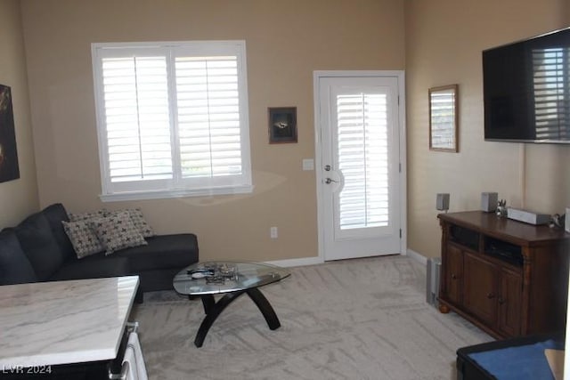 living room with light colored carpet and a healthy amount of sunlight