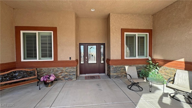 entrance to property with a patio area