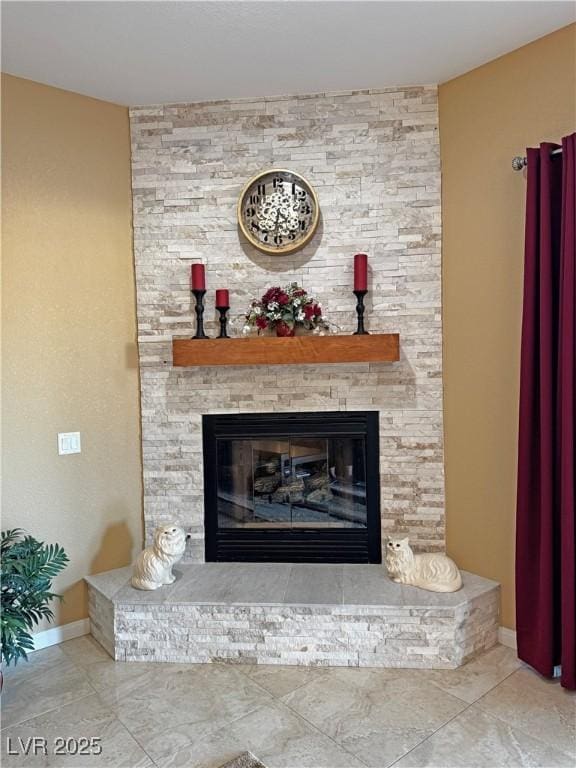 interior details featuring a stone fireplace