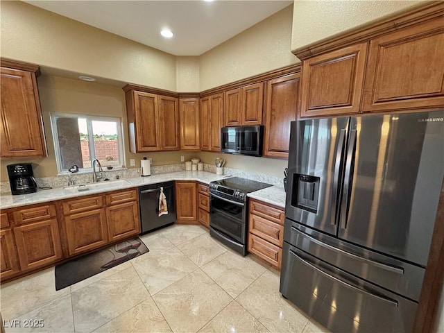 kitchen featuring appliances with stainless steel finishes, light stone countertops, and sink