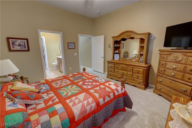 carpeted bedroom featuring ensuite bath