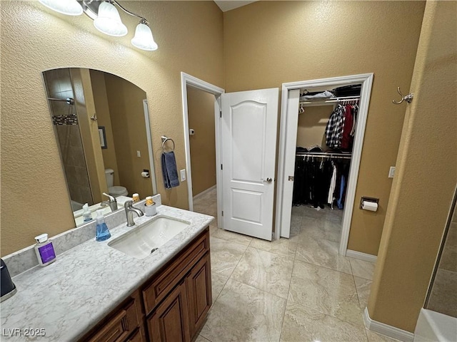 bathroom with vanity, toilet, and walk in shower