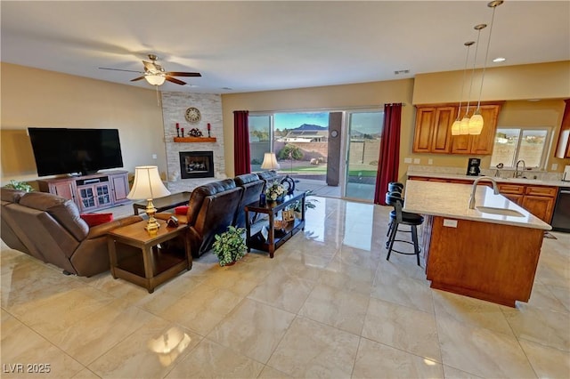 living room with sink, a wealth of natural light, and a fireplace