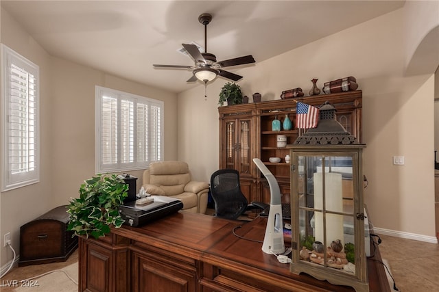 tiled home office with plenty of natural light and ceiling fan