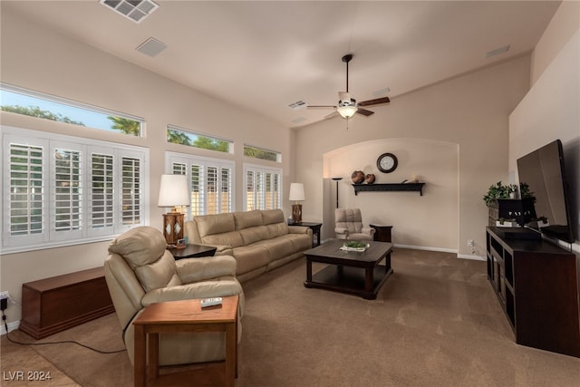 living room featuring carpet flooring, a wealth of natural light, and ceiling fan