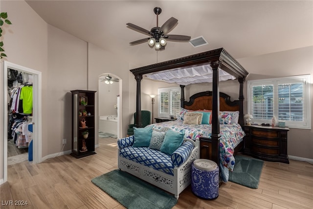 bedroom featuring ensuite bathroom, light hardwood / wood-style flooring, and ceiling fan