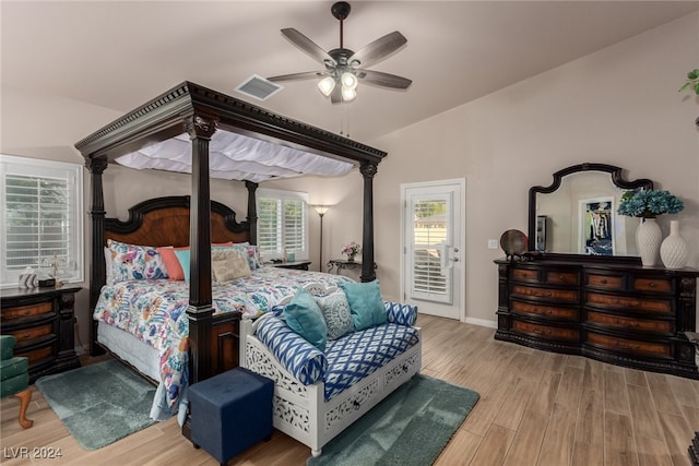 bedroom with hardwood / wood-style flooring, ceiling fan, access to exterior, and lofted ceiling