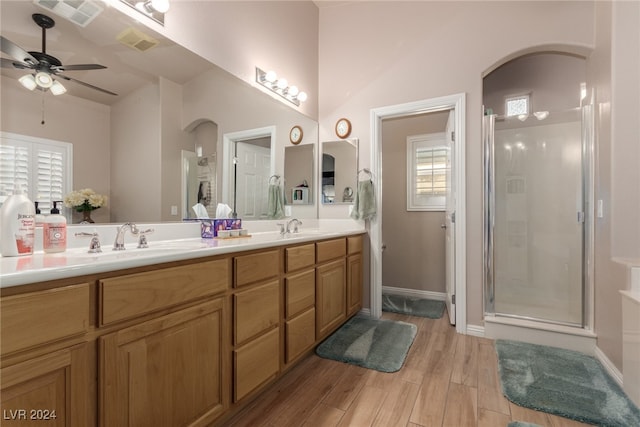 bathroom with an enclosed shower, hardwood / wood-style floors, plenty of natural light, and ceiling fan