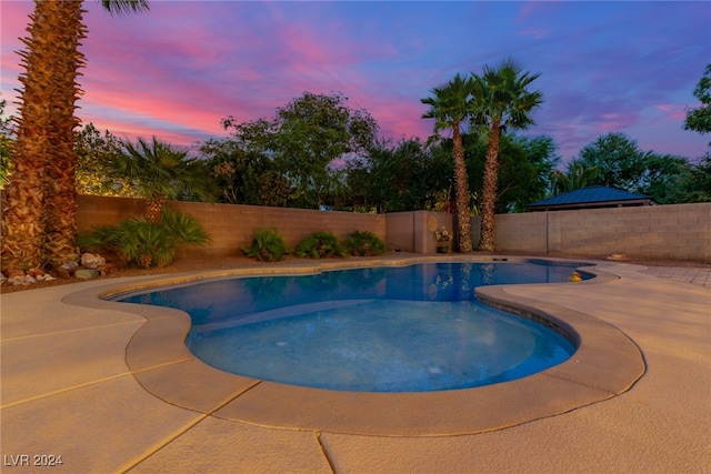 view of pool at dusk