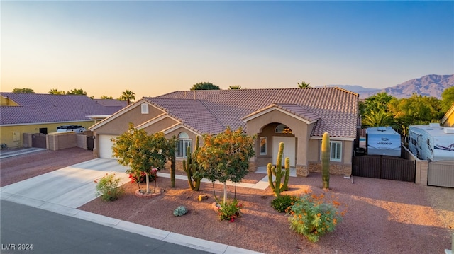 view of front of property featuring a mountain view and a garage