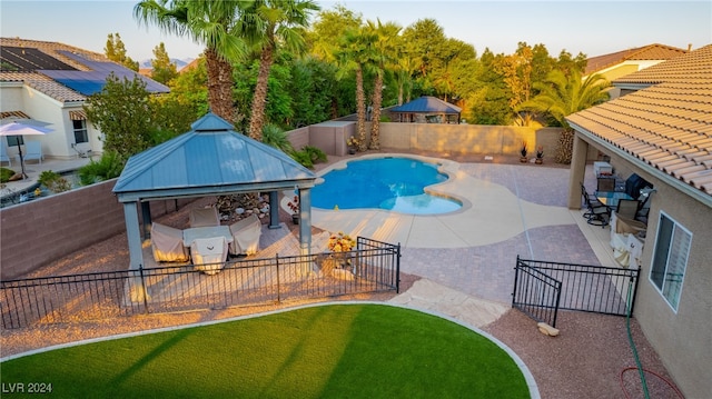 view of swimming pool with a gazebo, a patio, and a lawn