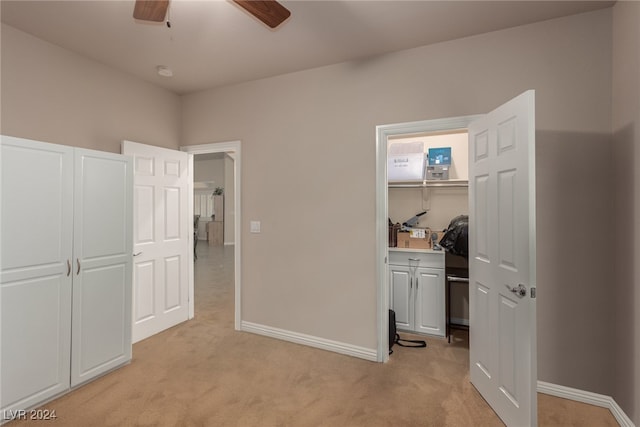 carpeted bedroom featuring ceiling fan and a closet