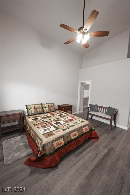 bedroom featuring dark hardwood / wood-style floors, ceiling fan, and lofted ceiling