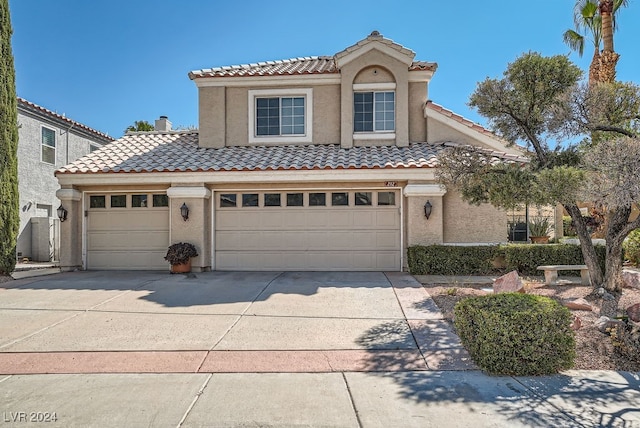 mediterranean / spanish house with a garage