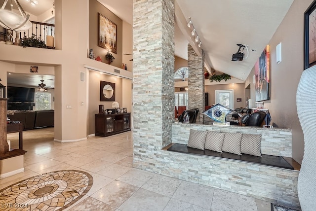 reception with ceiling fan and decorative columns