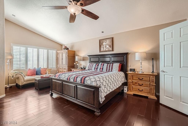 bedroom with a textured ceiling, ceiling fan, dark wood-style flooring, and vaulted ceiling