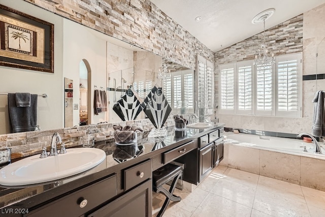 bathroom with vanity, lofted ceiling, tile patterned floors, and tiled bath