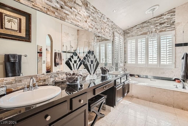 bathroom with a sink, lofted ceiling, a bath, and double vanity