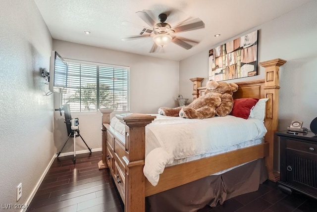bedroom with baseboards, a textured wall, a textured ceiling, a ceiling fan, and dark wood-style flooring