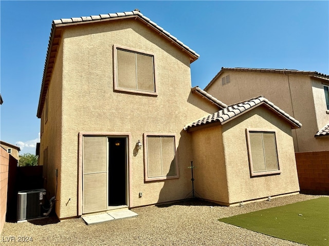 back of property featuring cooling unit