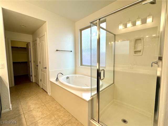 bathroom featuring separate shower and tub and tile patterned flooring