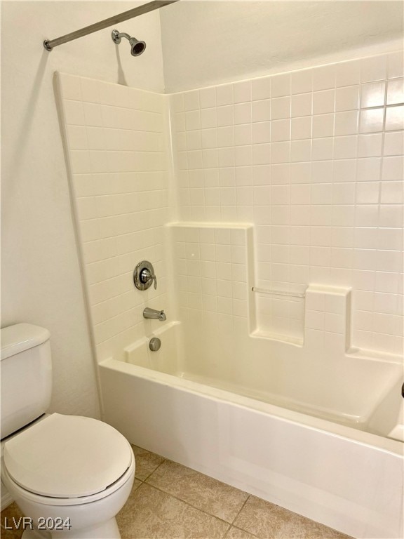 bathroom with toilet, tile patterned flooring, and  shower combination