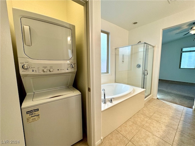 washroom featuring light tile patterned floors, ceiling fan, and stacked washing maching and dryer