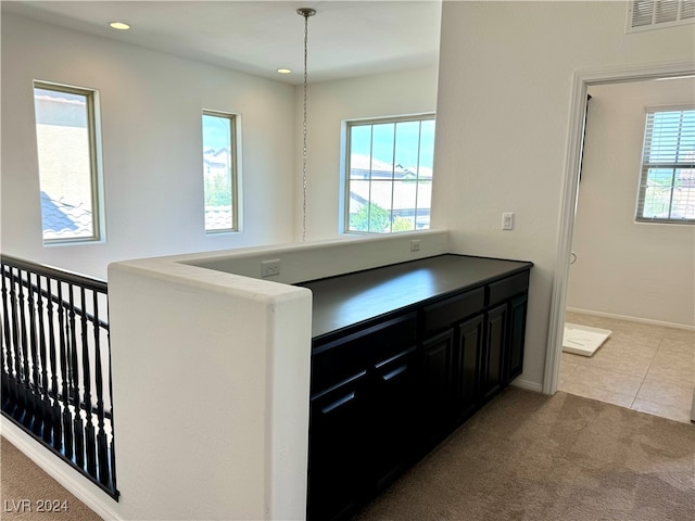 kitchen with pendant lighting, plenty of natural light, and carpet