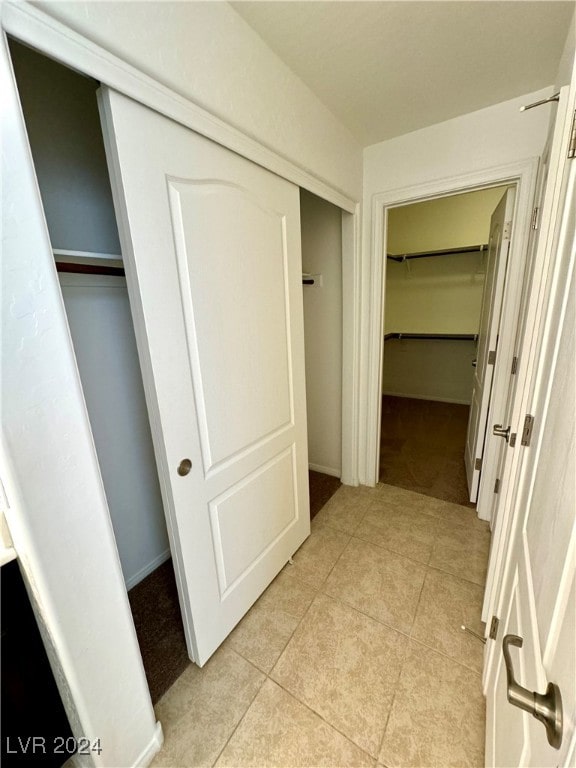 hall with light tile patterned floors