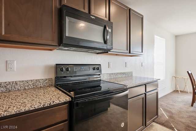 kitchen featuring black appliances, light colored carpet, light stone countertops, and dark brown cabinetry