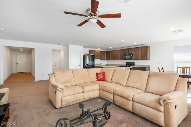 living room with ceiling fan and light carpet