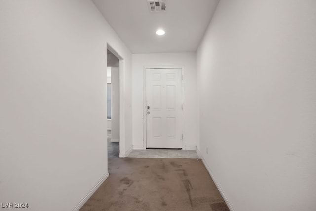 hallway featuring light colored carpet