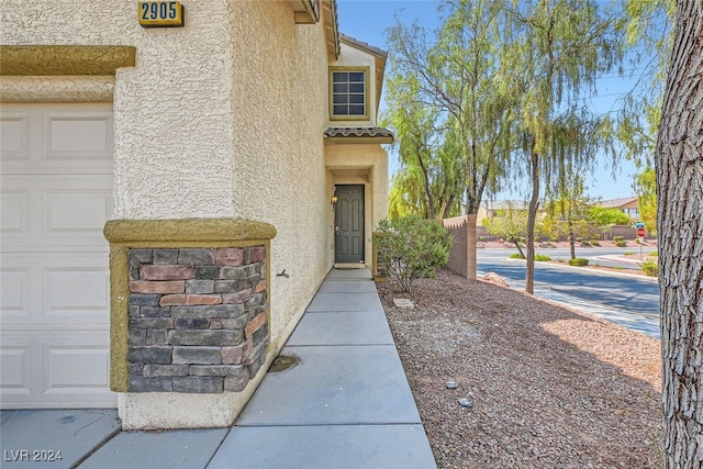 view of exterior entry with a garage