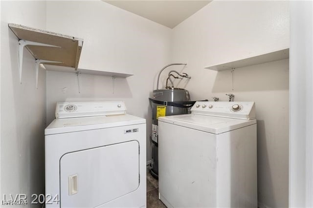 laundry area with washer and clothes dryer and water heater