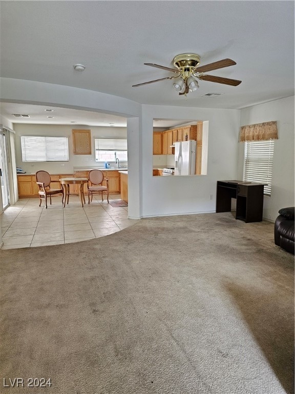 living room featuring ceiling fan and light tile patterned floors