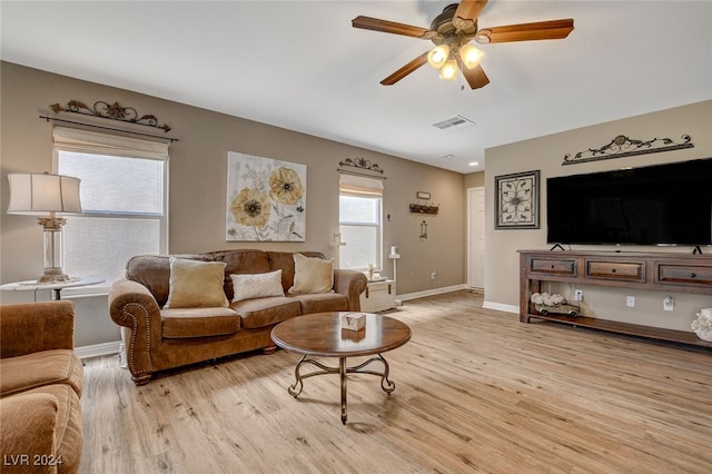 living room with light hardwood / wood-style flooring and ceiling fan