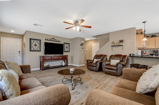 living room featuring ceiling fan and light wood-type flooring