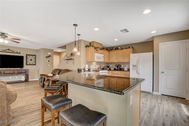 kitchen featuring white appliances, light hardwood / wood-style floors, light brown cabinets, kitchen peninsula, and ceiling fan