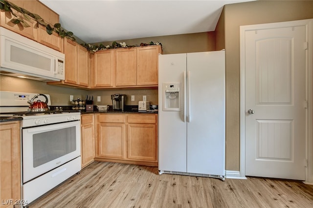 kitchen featuring white appliances and light hardwood / wood-style flooring