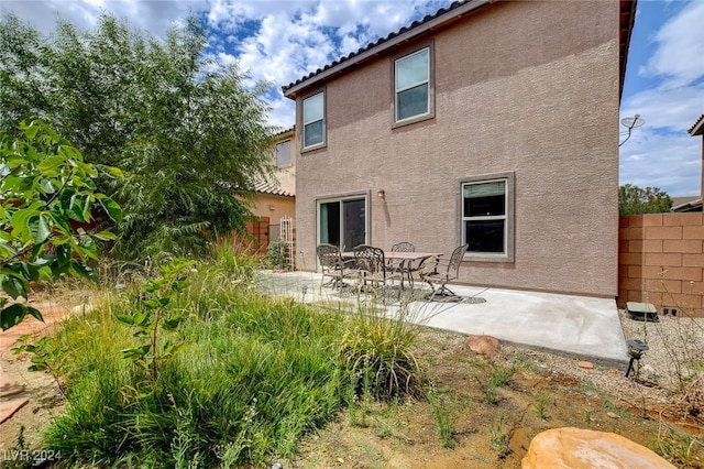 back of property with a patio