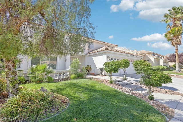 view of front of house featuring a garage and a front yard