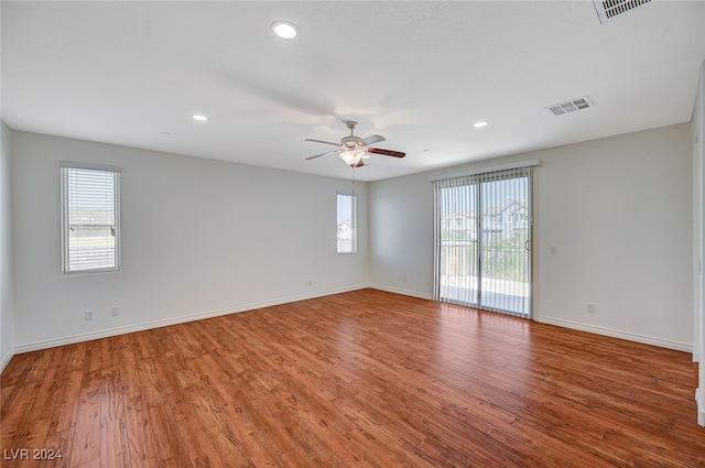 empty room with ceiling fan and wood-type flooring