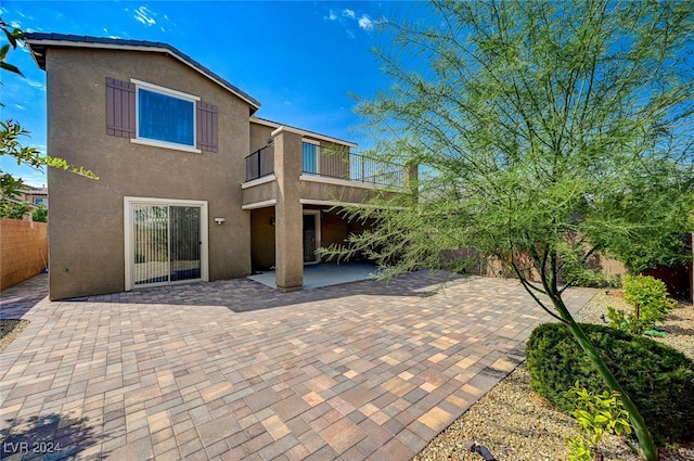 back of house with a patio and a balcony